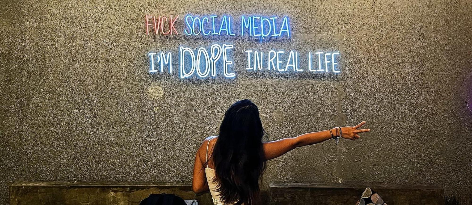 Stellar Capsules Hostel Seminyak  Exterior photo A woman in front of a neon sign